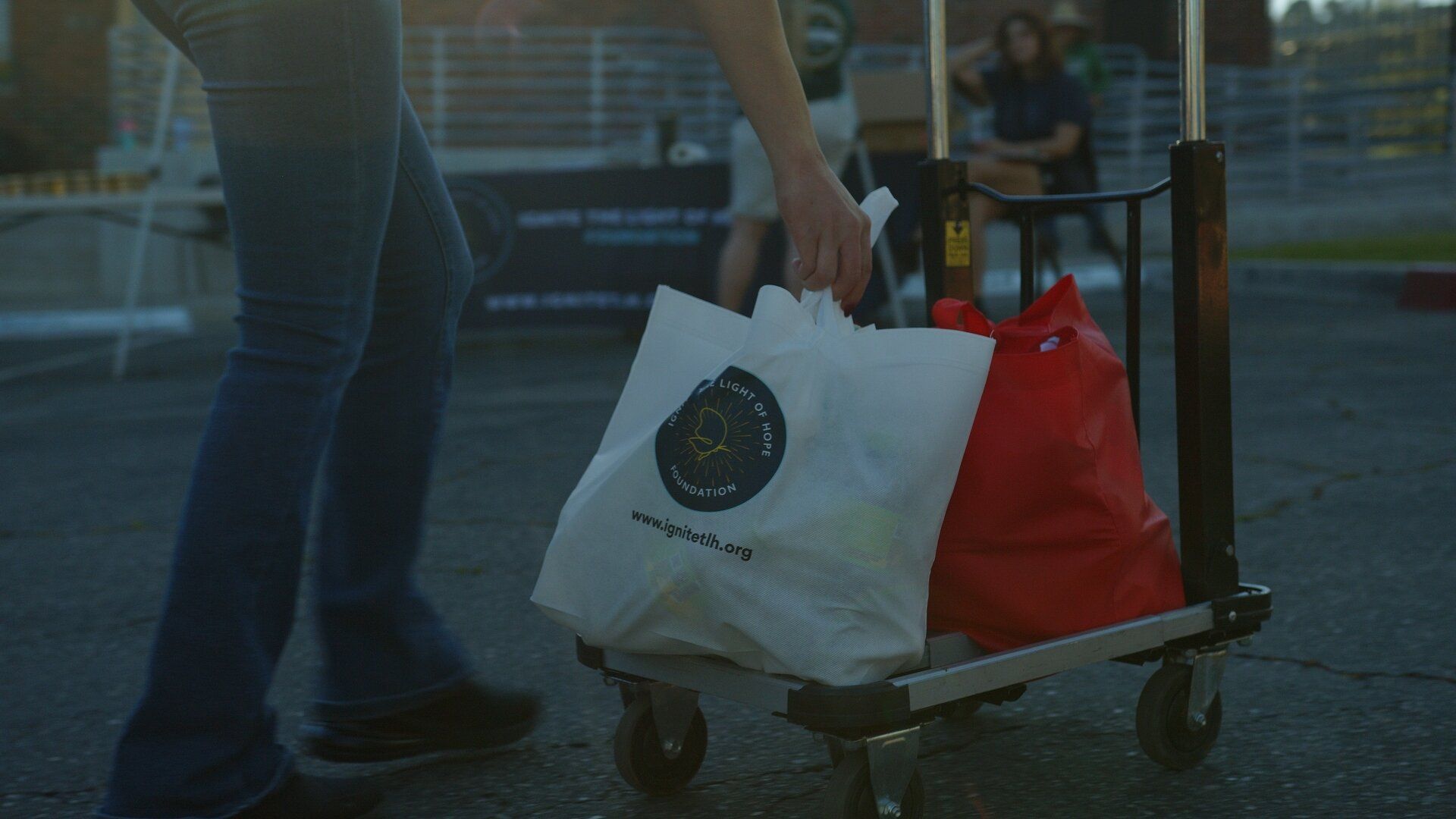An Ignite The Light Of Hope grocery bag rolled out on a cart